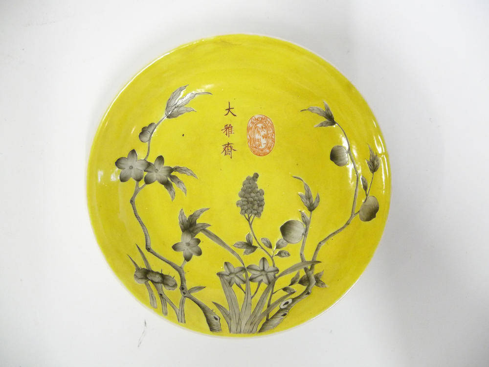 Lot 143 - A Chinese Porcelain Yellow Ground Saucer Dish, 19th century, painted en grisaille with fruiting and