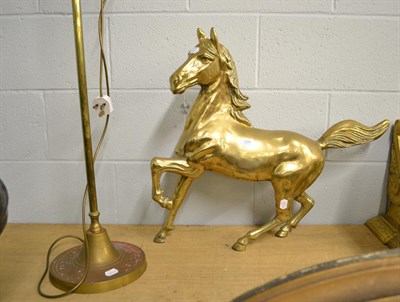 Lot 396 - A brass statue of a stallion mid canter, 68cm long together with a brass adjustable table lamp (2)