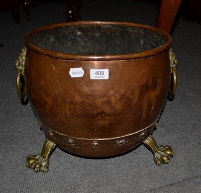 Lot 409 - A 19th century copper log bucket, with ring and lion mask and paw feet