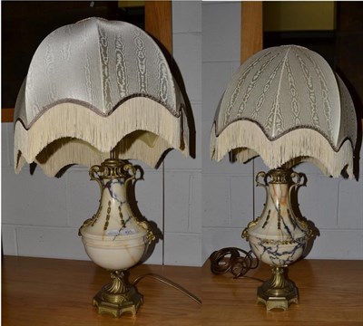 Lot 421 - A pair of Neo-Classical style gilt metal mounted marble table lamps of urn form and ornamented with