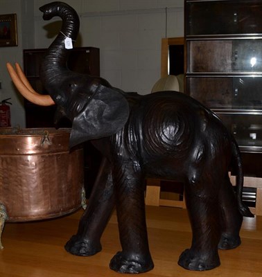 Lot 423 - A leather covered model of a baby elephant, 20th/21st century, with composition tusks, 99cm high