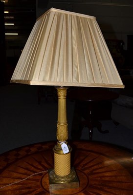 Lot 432 - A gilt bronze table lamp, in Louis XVI style, of fluted baluster form with leaf sheathed...