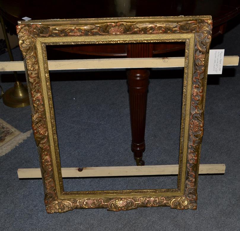 Lot 1077 - A giltwood picture frame circa 1900, overall 66cm by 82cm, aperture 64cm by 49cm