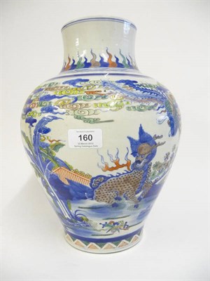 Lot 160 - A Chinese Wucai Porcelain Baluster Jar in 17th Century Style, painted with a kylin in a fenced...