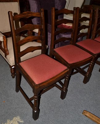 Lot 1106 - A set of seven reproduction ladder back dining chairs