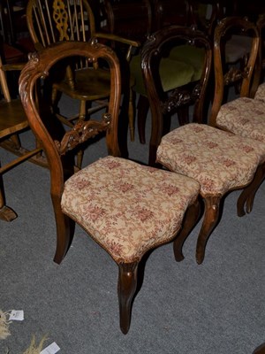Lot 1109 - A set of six Victorian carved rosewood balloon back dining chairs