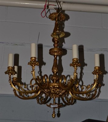 Lot 1114 - A gilt metal 8-light chandelier with reeded arms decorated with ribbon tied swags, drop...