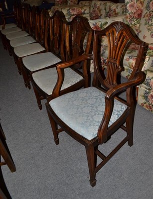 Lot 1124 - A set of eight Hepplewhite style carved mahogany dining chairs including a pair of carver armchairs