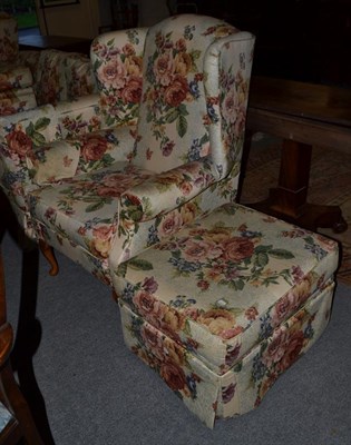 Lot 1125 - A pair of floral upholstered wing back arm chairs; together with a three-seater sofa and pair...