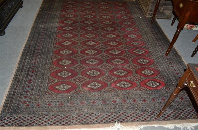 Lot 1138 - A Larhore ''Bukhara'' carpet, the cherry red field of serrated guls enclosed by multiple...