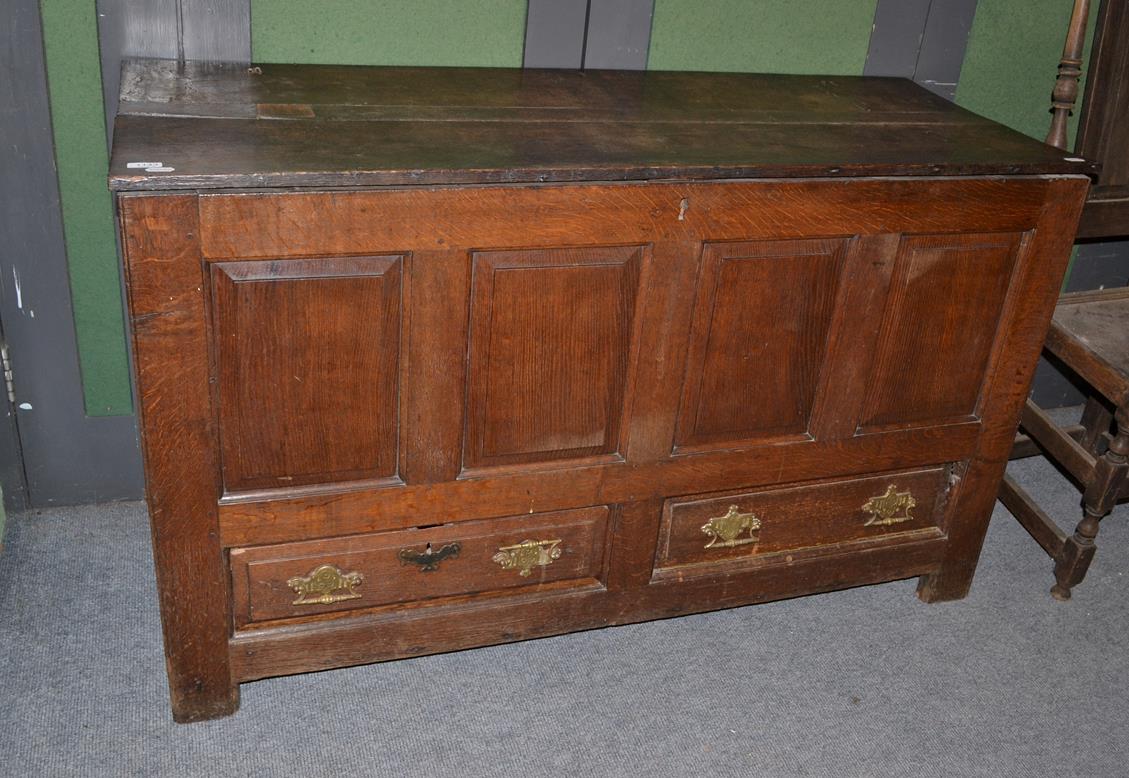 Lot 1143 - A joined oak chest with hinged lid