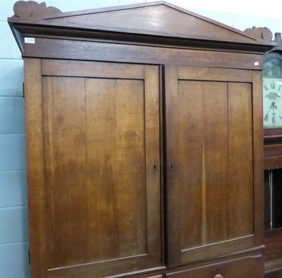 Lot 1148 - A 19th century oak linen press, the upper section fitted with shelves, 132cm by 56cm by 219cm high