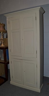 Lot 1149 - A 19th century painted pine farmhouse kitchen cabinet of slender form, with panelled doors,...