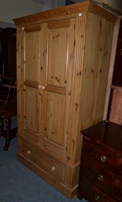 Lot 1156 - A modern pine wardrobe, 110cm by 57cm by 194cm high