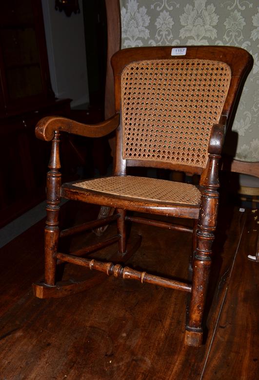 Lot 1157 - A 19th century elm cane childs rocking chair