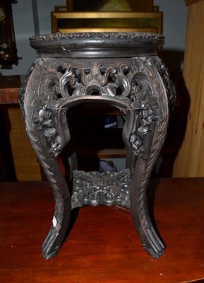 Lot 1162 - A Chinese pierced and carved hardwood marble top plant stand, 33cm diameter by 47cm