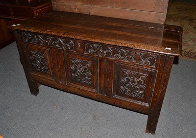 Lot 1170 - An 18th century carved oak three panel coffer, 130cm by 56cm by 73cm high