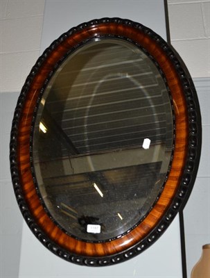 Lot 1187 - A mahogany oval mirror, 87cm by 62cm