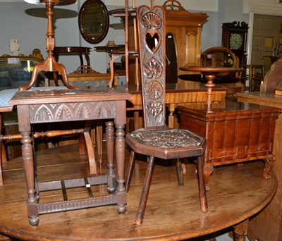Lot 1197 - A carved oak spinning chair, a carved oak occasional table with twin brass stretchers and a...