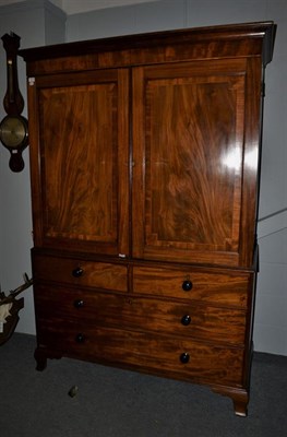 Lot 1213 - A Georgian mahogany linen press, fitted with dressing slides, 136cm by 60cm by 197cm high