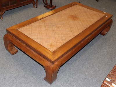 Lot 1228 - A 20th century Chinese hardwood coffee table with a rattan top, 166cm wide by 86cm deep by 42cm...