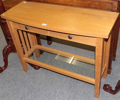 Lot 1237 - A Treske Furniture bespoke solid oak console table, the bowed rectangular top over a pair of...