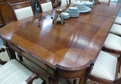 Lot 1247 - An impressive reproduction crossbanded mahogany gilt metal mounted extending dining table with...