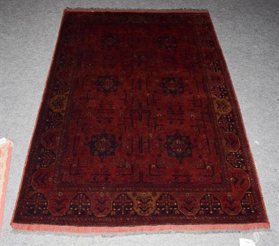 Lot 1249 - An Afghan Turkmen rug, the compartmentalised field enclosed by narrow borders, 195cm by 128cm