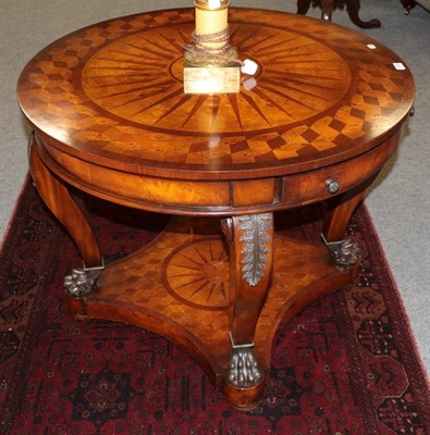 Lot 1250 - A reproduction bur walnut and mahogany veneered drum table, the circular top supported by four gilt