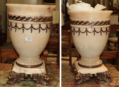 Lot 1254 - A pair of modern marble and alabaster gilt metal mounted urns in Classical taste on lion mask feet
