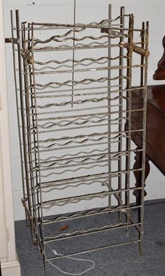 Lot 1268 - A pair of wrought metal bottle racks, 57cm by approx 135cm