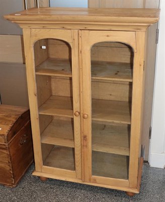 Lot 1280 - A glazed pine bookcase, 91cm by 45cm by 128cm high