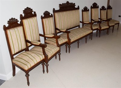 Lot 1291 - ~ A Continental walnut nine piece suite comprising; a settle, pair of armchairs, six single chairs