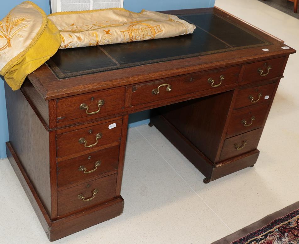 Lot 1300 - A leather inset oak pedestal desk, 120cm by 60cm by 74cm high