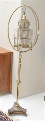 Lot 1301 - ~ A North African style floor standing brass bird cage with adjustable standard