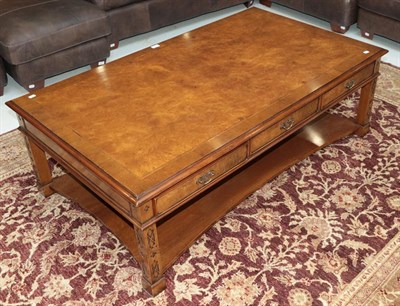 Lot 1323 - A reproduction burr walnut coffee table, with blind fretwork, and three drawers opposed by dummies