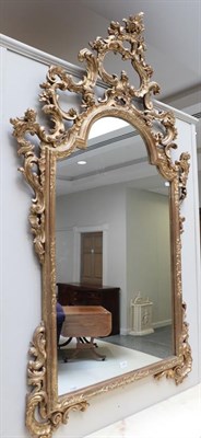 Lot 1325 - A carved and gilt composition Rococo style mirror decorated with scrolling acanthus leaves,...