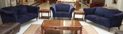 Lot 1327 - A three piece suite, modern, covered in purple velvet, comprising a pair of two-seater sofas...