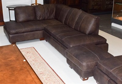 Lot 1331 - A brown leather corner settee with matching footstool, 230cm by 180cm