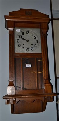 Lot 1342 - An Art Deco oak cased striking wall clock