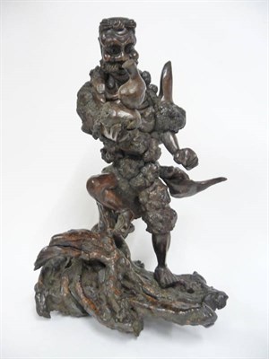 Lot 187 - A Chinese Carved Rootwood Figure of a Daoist Immortal, late 19th century, the emaciated sage...