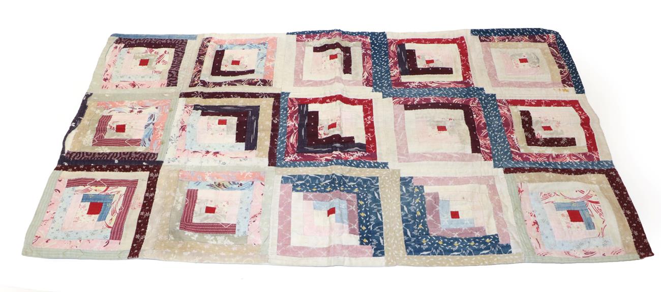 Lot 2020 - Late 19th Century Log Cabin Cot Quilt, the small red square to the centre depicts a fire in the log