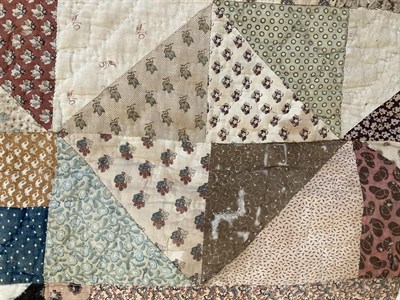 Lot 2021 - A Large 19th Century Patchwork Quilt, comprising a central square with small frames around a...