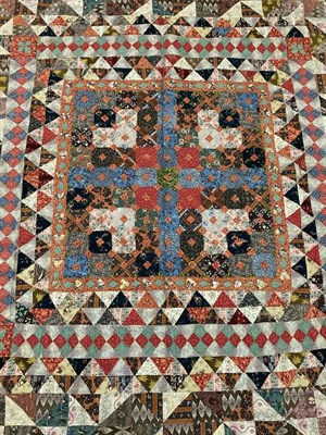 Lot 2024 - A 19th Century Reversible Patchwork Quilt, incorporating vibrant patches of mainly floral...