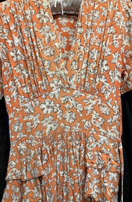Lot 2061 - Circa 1920-30s Day and Evening Wear, comprising a short sleeved orange and grey floral day...