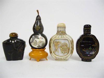 Lot 204 - A Chinese Lac Burgaute Snuff Bottle, of octolobed outline, worked on both sides with pavilion...