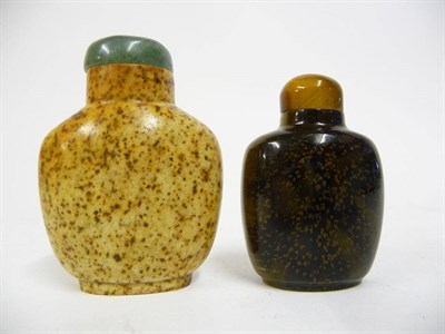 Lot 212 - A Chinese Solid Tiger's Eye Snuff Bottle, circa 1900 or later, the stone attractively flecked,...