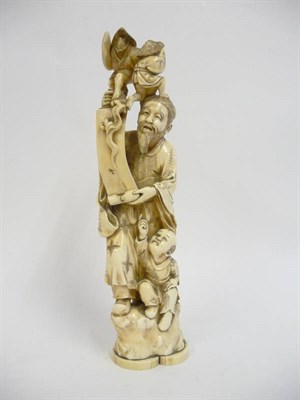 Lot 233 - A Japanese Marine Ivory Okimono, Meiji period (1868-1912), as a bearded man holding a scroll,...