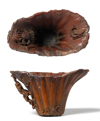 Lot 247 - A Chinese Carved Rhinoceros Horn Libation Cup, 17th century, formed as a flared lotus leaf, the...