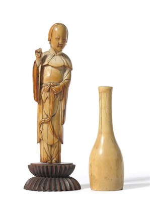 Lot 250 - A Chinese Carved Elephant Ivory Figure of a Maiden, 18th century, the slender enrobed figure...